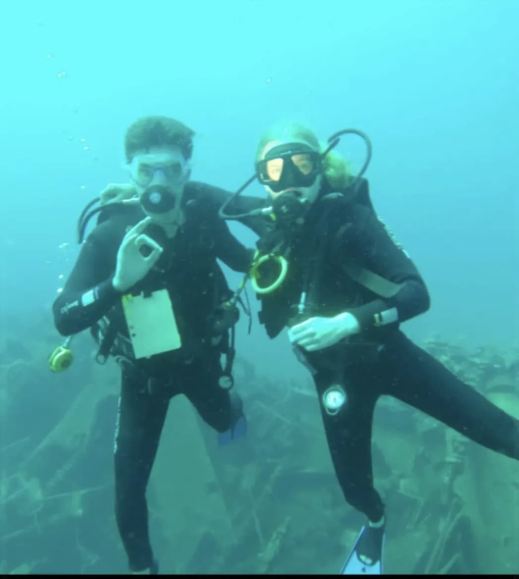 Giovanni diving underwater with sister
