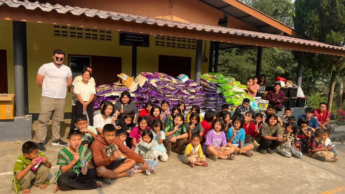 Giovanni with children at Bilay House after rice delivery