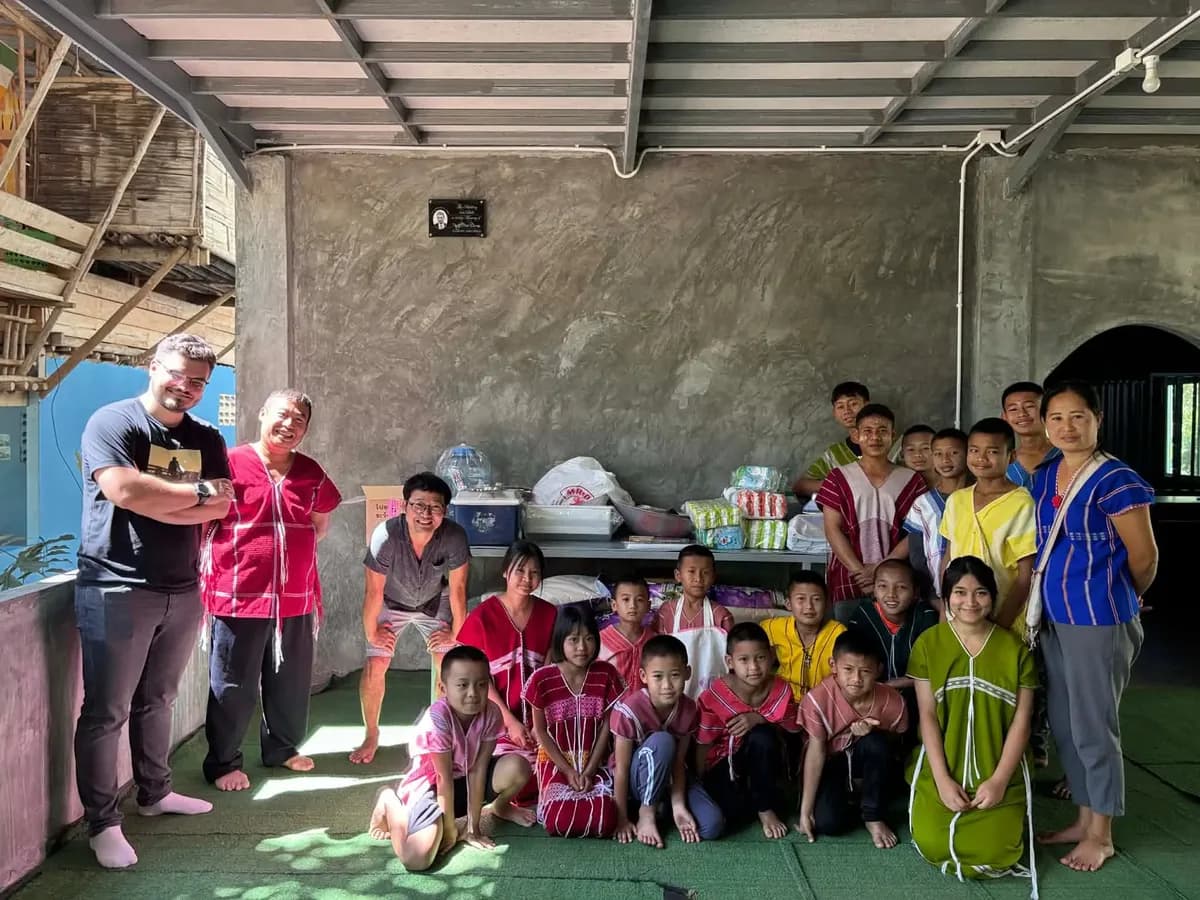 Kids in traditional Karen dress receiving rice