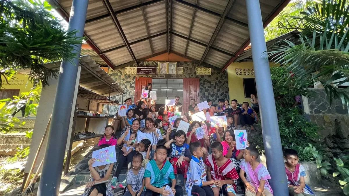 Kids holding up drawings